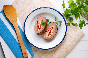 Roll of minced meat stuffed with red pepper, ham and cheese. Traditional Spanish recipe.
