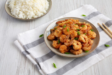 Homemade Crispy Salt and Pepper Shrimp with Scallions on a Plate, low angle view.