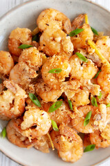 Homemade Crispy Salt and Pepper Shrimp with Scallions on a Plate, top view. Flat lay, overhead, from above.