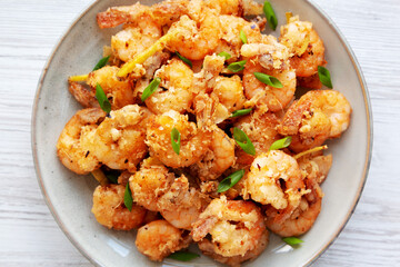 Homemade Crispy Salt and Pepper Shrimp with Scallions on a Plate, top view. Flat lay, overhead, from above.