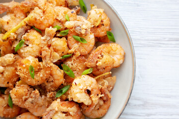 Homemade Crispy Salt and Pepper Shrimp with Scallions on a Plate, top view. Flat lay, overhead, from above. Copy space.