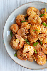Homemade Crispy Salt and Pepper Shrimp with Scallions on a Plate, top view. Flat lay, overhead, from above. Close-up.
