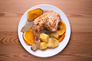 Baked chicken cooked with orange and potatoes. Traditional Spanish recipe.