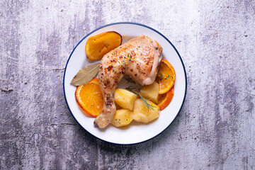 Baked chicken cooked with orange and potatoes. Traditional Spanish recipe.