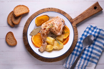 Baked chicken cooked with orange and potatoes. Traditional Spanish recipe.