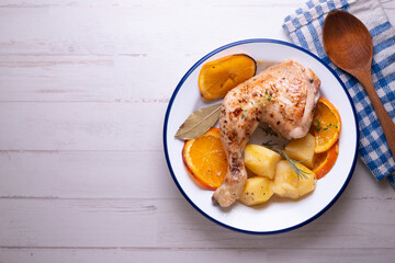 Baked chicken cooked with orange and potatoes. Traditional Spanish recipe.