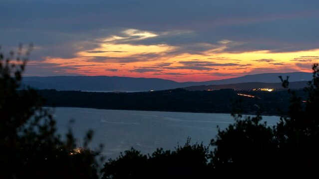 Time lapse shot of colorful dusk over bay Puntarska draga and mountain Mihovilov with clouds