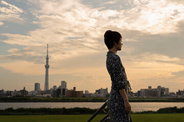 夕方 河川敷 ショートヘアの女性