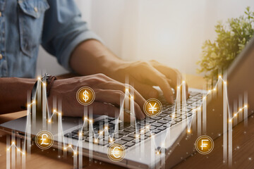 Casual Businessman Using or Typing Laptop and Unstable Currency Stock Market Bar Chart and Graph Trend