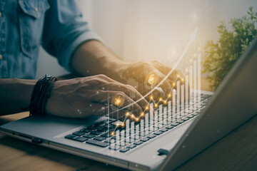 Casual Businessman Using or Typing Laptop and Currency Stock Market Bar Chart or Graph Trend in Vintage Tone