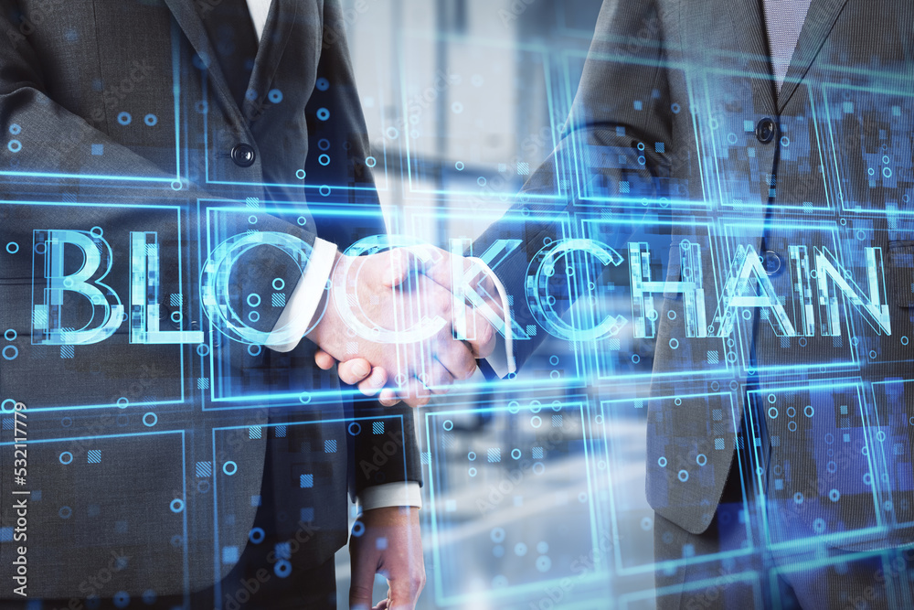 Poster close up of businessmen shaking hands with creative blue cubes blockchain text hologram. technology 