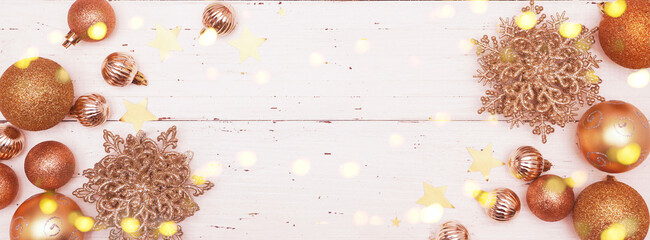  Christmas or New Year Decoration, background. Christmas Ornament with gold Christmas baubles, snowflakes and stars on an old rustic white wooden table. Christmas lights.