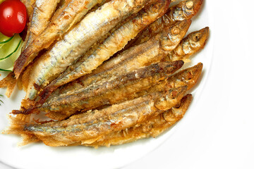 Pan fried crispy smelt, close-up. Close-up, selective focus. White background.