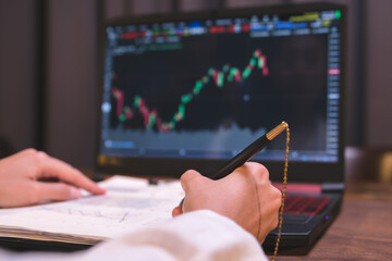 Stock analysts are checking trading charts for stock growth to analyze investment risks, Find financial management information from the graph to increase investment stability. © Wasaphol