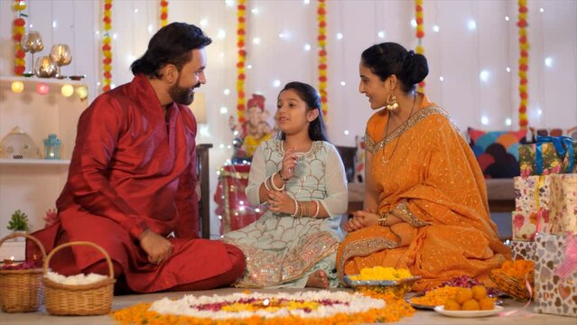 Small Indian family during Diwali celebration - Indian woman with her husband and daughter  parents with children. Indian parents with their daughter during the Diwali holidays - happy family  fami...