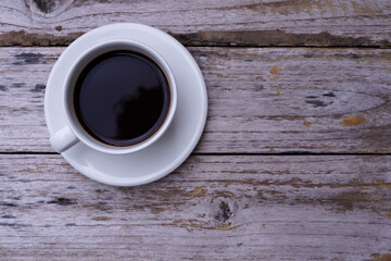 hot americano coffee on old wooden table.