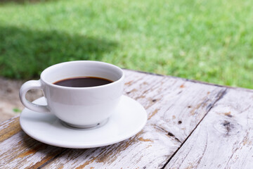 hot americano coffee on old wooden table.