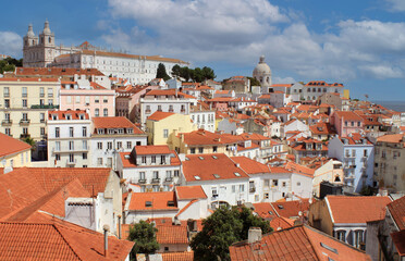 The Monastery of St. Vincent and exterior view of beautiful historical buildings, rooftops, and church towers in downtown Lisbon, Portugal Europe. Mediterranean old townhouses in Alfama neighborhood.