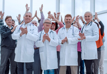 doctors and a group of mature people applaud