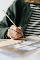 Woman paints with a brush paints on a sheet