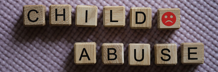 Text abuse child angry emoticon on cubes closeup