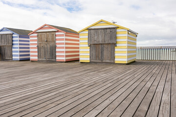 colourfull pier huts on hastings pier, copy space