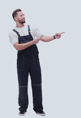 smiling man in overalls pointing to a copy of the space