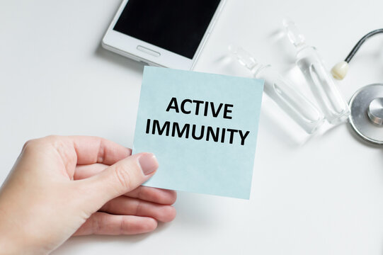 Text Active Immunity on the white card with the stethoscope and medical documents. Medical concept photo