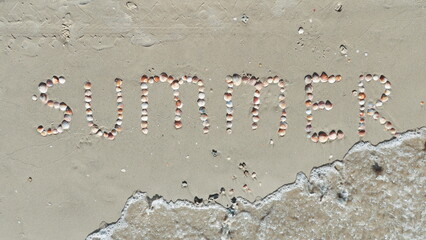 The inscription is lined with shells on the sand. Summer Conception