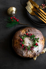 Top view of Panettone, Italian fruity enriched sweet bread on tetable with  cutlery abd  Chrisdtmas...