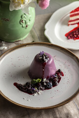 Delicious Italian dessert Panna Cotta with fresh blueberries on a white plate