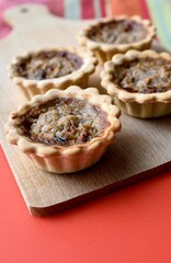 Pissaladière tartlets close up vertical image
