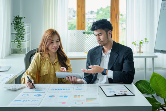A portrait of a female business owner consulting a male salesperson to devise a strategy to increase revenue from new incoming goods using investment budget documents and an analytical computer