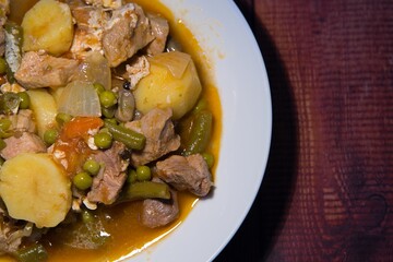 Meat stew on your plate on a wooden background. world food day concept.