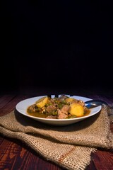 Meat stew on your plate on a wooden background. world food day concept.
