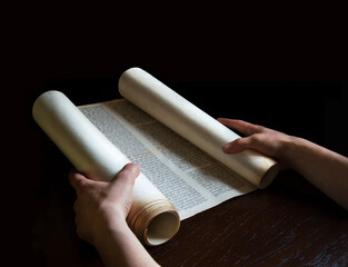 Hands holding an ancient scroll