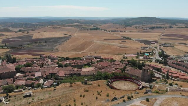 Impressive aerial view from the Cid Castle towards Atienza, Guadalajara (Spain), with a Spanish flag waving on top of the castle