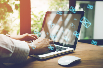 newsletter concept Hand of businessman checking message box on digital laptop Vintage tone filter....