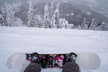 Fototapeta na wymiar snowboarder at the hill enjoying mountains landscape