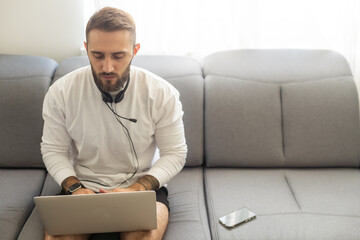 Bearded hipster style adult man working writing, freelance home sitting male typing on keyboard