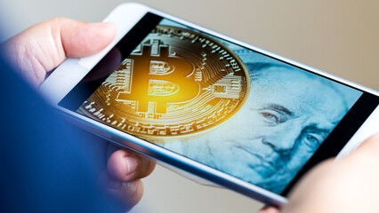 Bitcoin (BTC) on screen smartphone with symbol on FRANKLIN US USD. Virtual cryptocurrency that can...