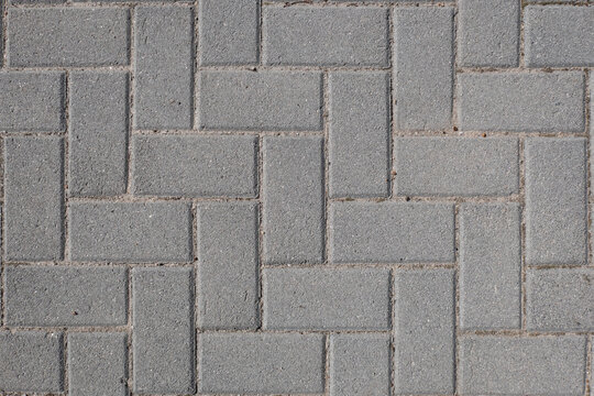 Textura de pavimento de paralelep&iacute;pedo cinza empilhados lado a lado formando uma cal&ccedil;ada