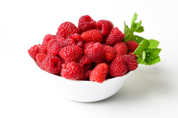 Fresh raspberries in the white bowl isolated on white background. Fresh raspberries close up