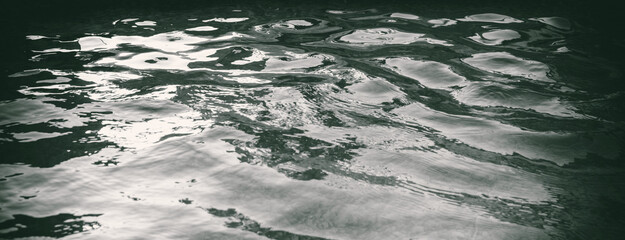 Abstract Water Surface. Full frame panorama banner with rippled water. Monochrome textured water surface.