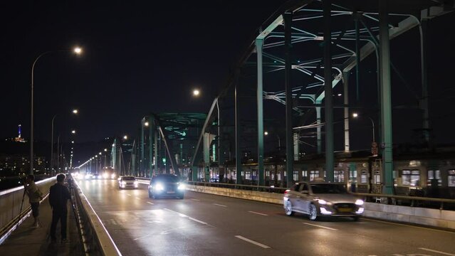 Dongjak bridge at night - cars traffic, Seoul metro train travel on bridge railroad, photographers take pictures of the night downtown cityscape and Han river