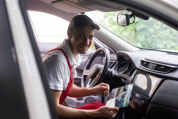 car service, repair, technology, maintenance and people concept - mechanic man with tablet pc computer making system diagnostic at workshop