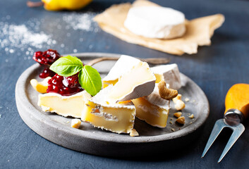 Camembert cheese with jam on gray plate