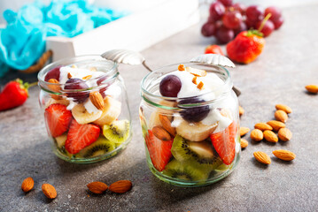 Summer fruit salad with white cream and almonds