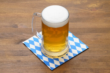 Oktoberfest Mug of beer on a napkin with a blue and white symbolic pattern beer and food festival, an annual German festival