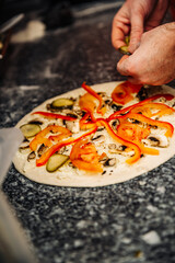 hand of chef baker making pizza at kitchen. The process of making pizza. cooking italian pizza